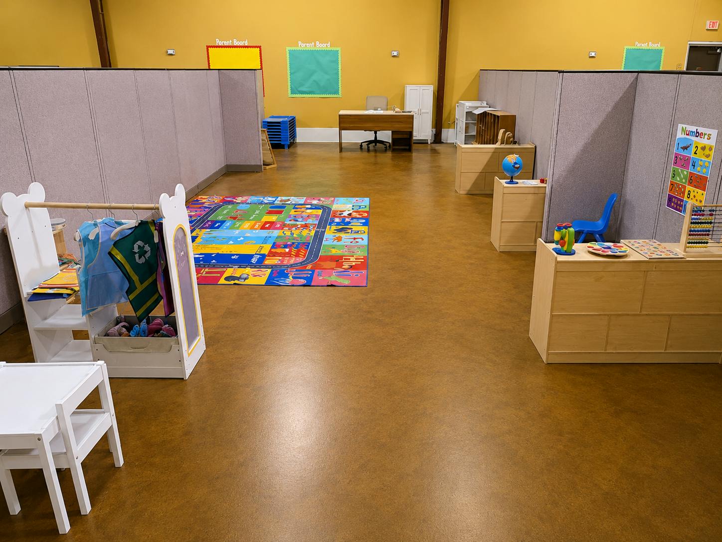 Classroom interior with play rugs, small furniture, and educational toys