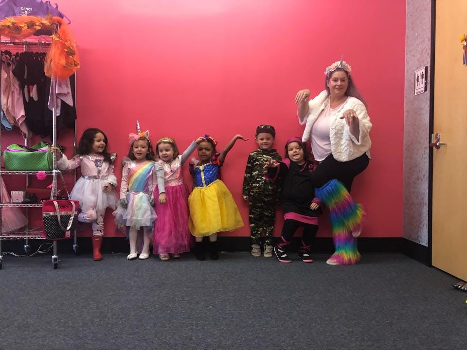 Adult and children in costumes posing for a photo