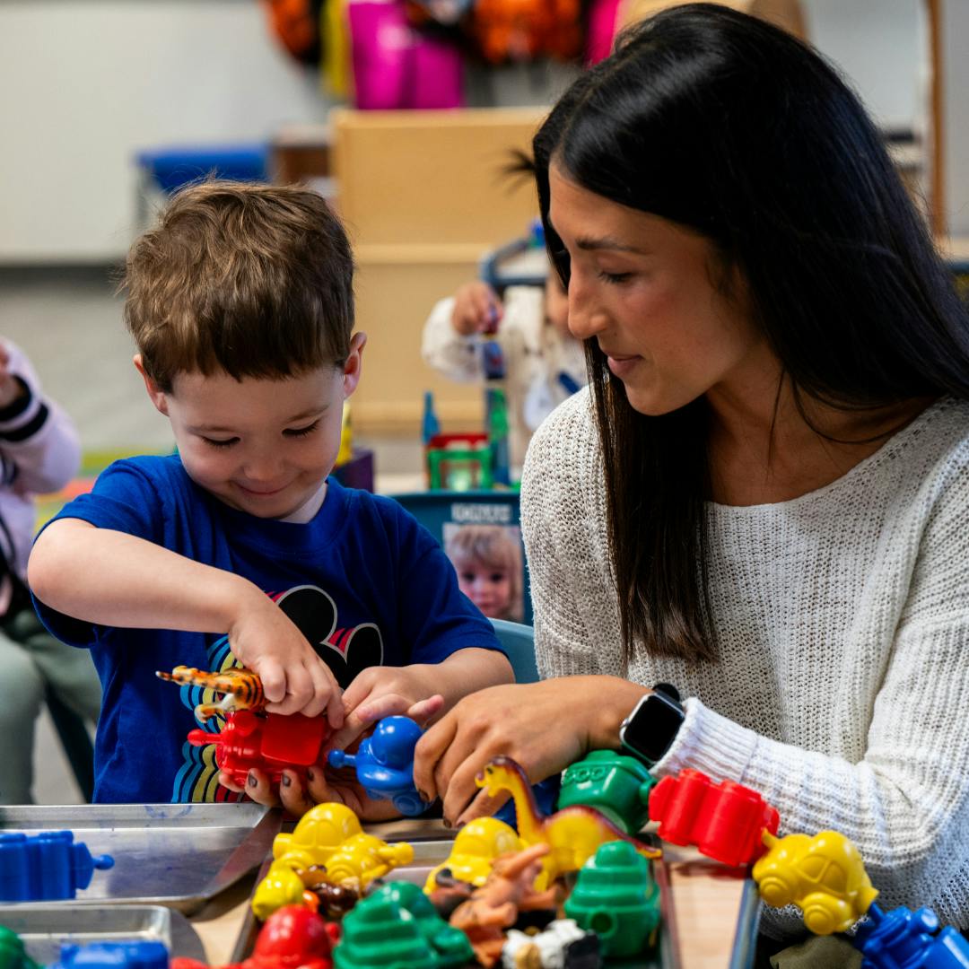 Adult and child playing with colorful toys