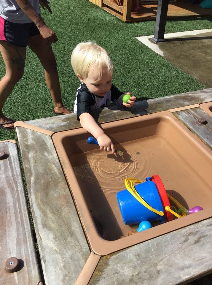 Child playing with water in a sensory table