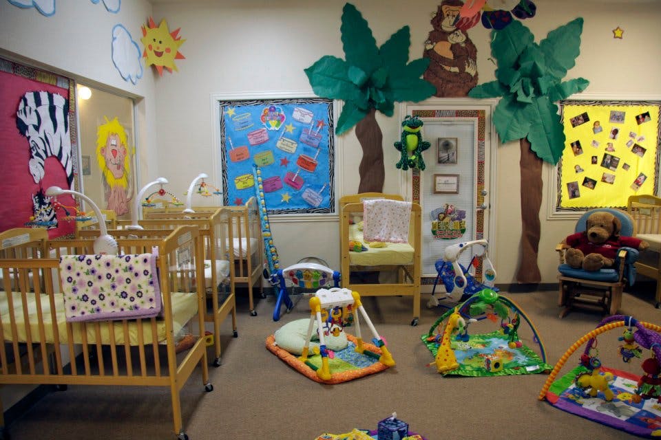 Nursery room with multiple cribs and playmats