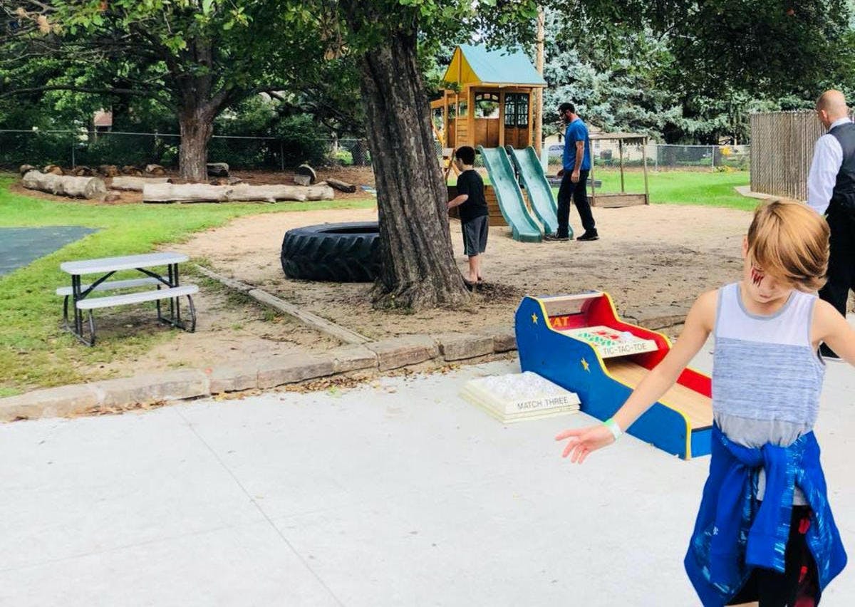 Child in foreground with playground in background