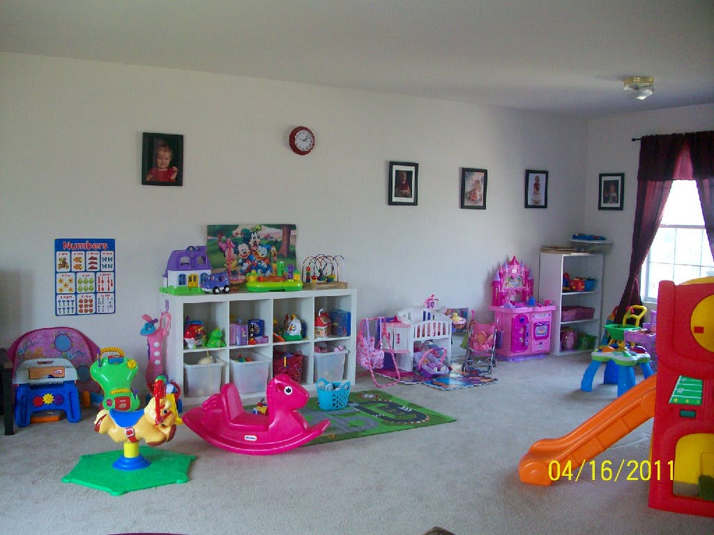 Playroom with various toys, including a rocking horse and a slide