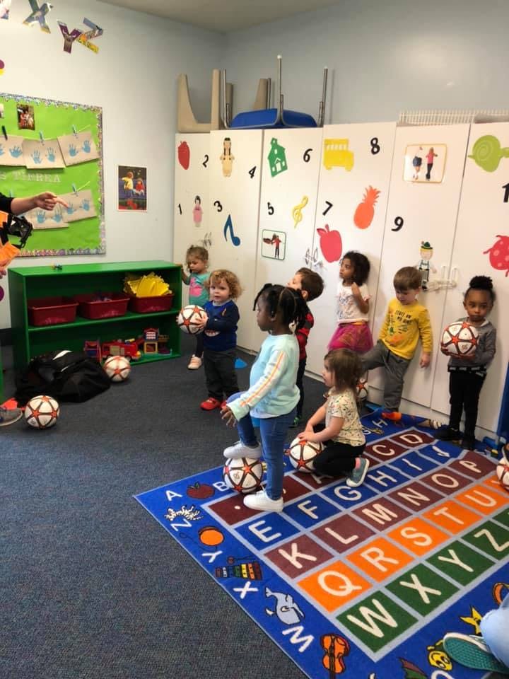 Children in a classroom with soccer balls
