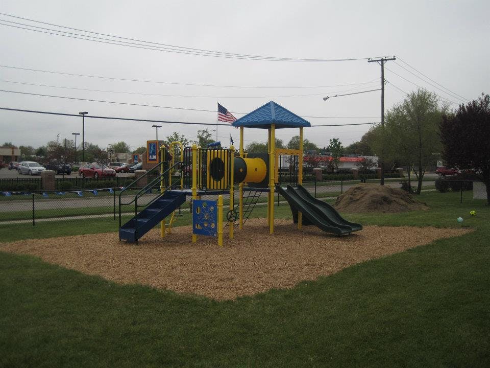 Playground with slides and climbing structure on wood chips