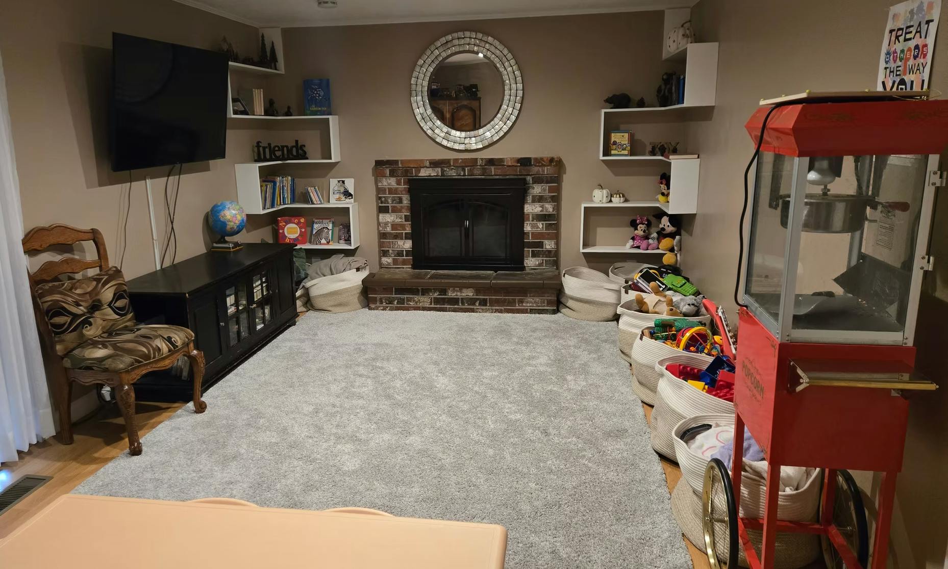 Living room with fireplace, television, and popcorn machine