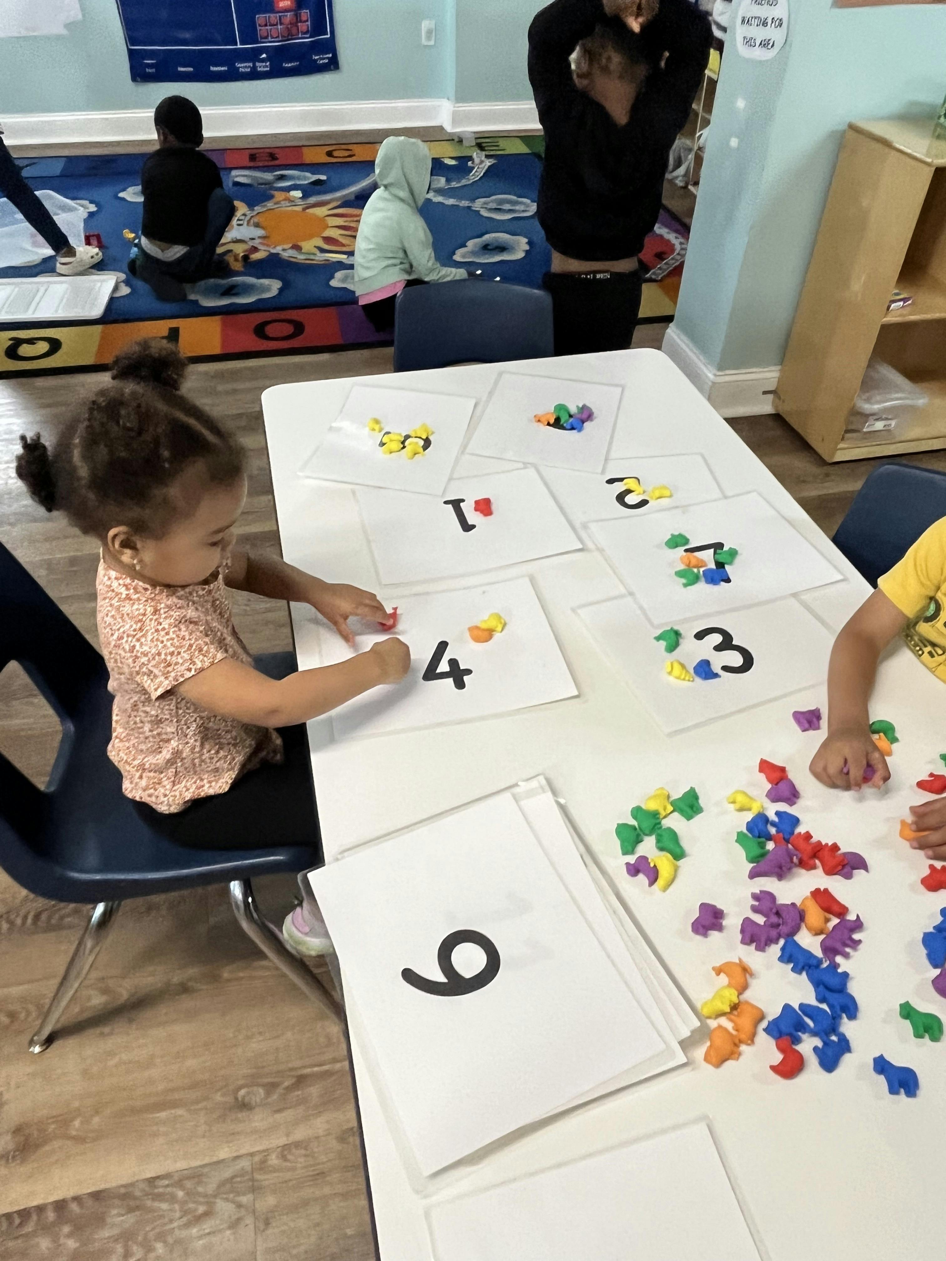 Child learning numbers using colorful animal counters in a classroom