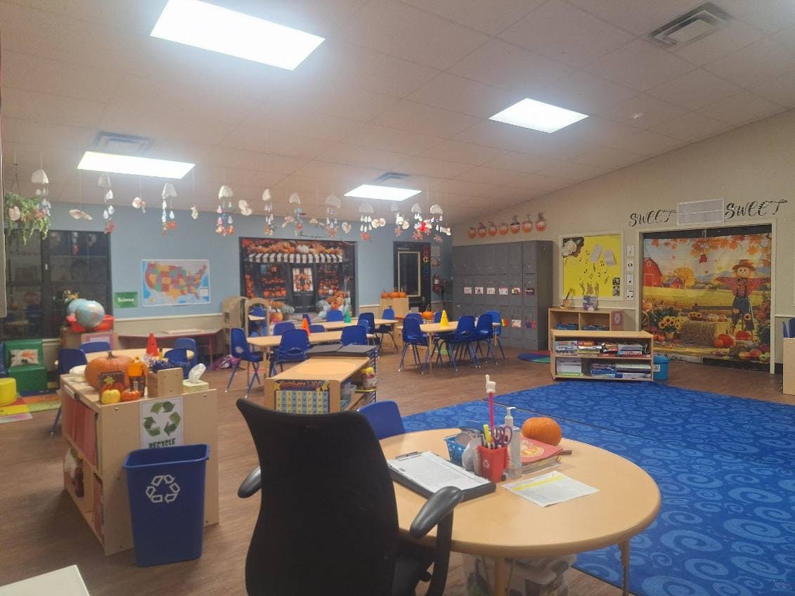 Classroom decorated with pumpkins and fall-themed art, hanging ornaments