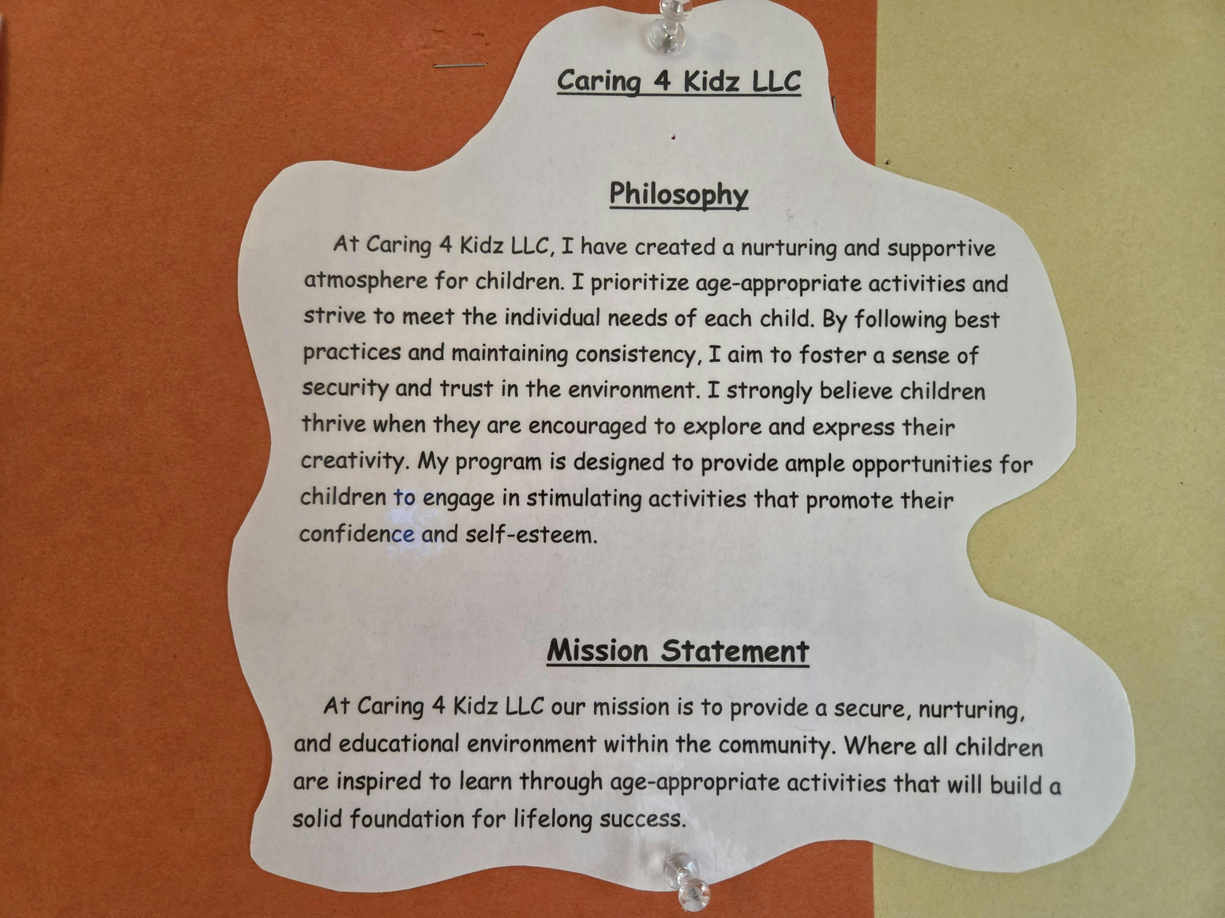 Caring 4 Kidz LLC philosophy and mission statement document on a wall