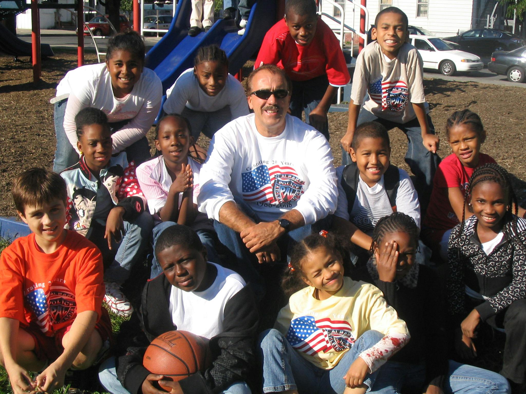 Adult and group of children posing outdoors