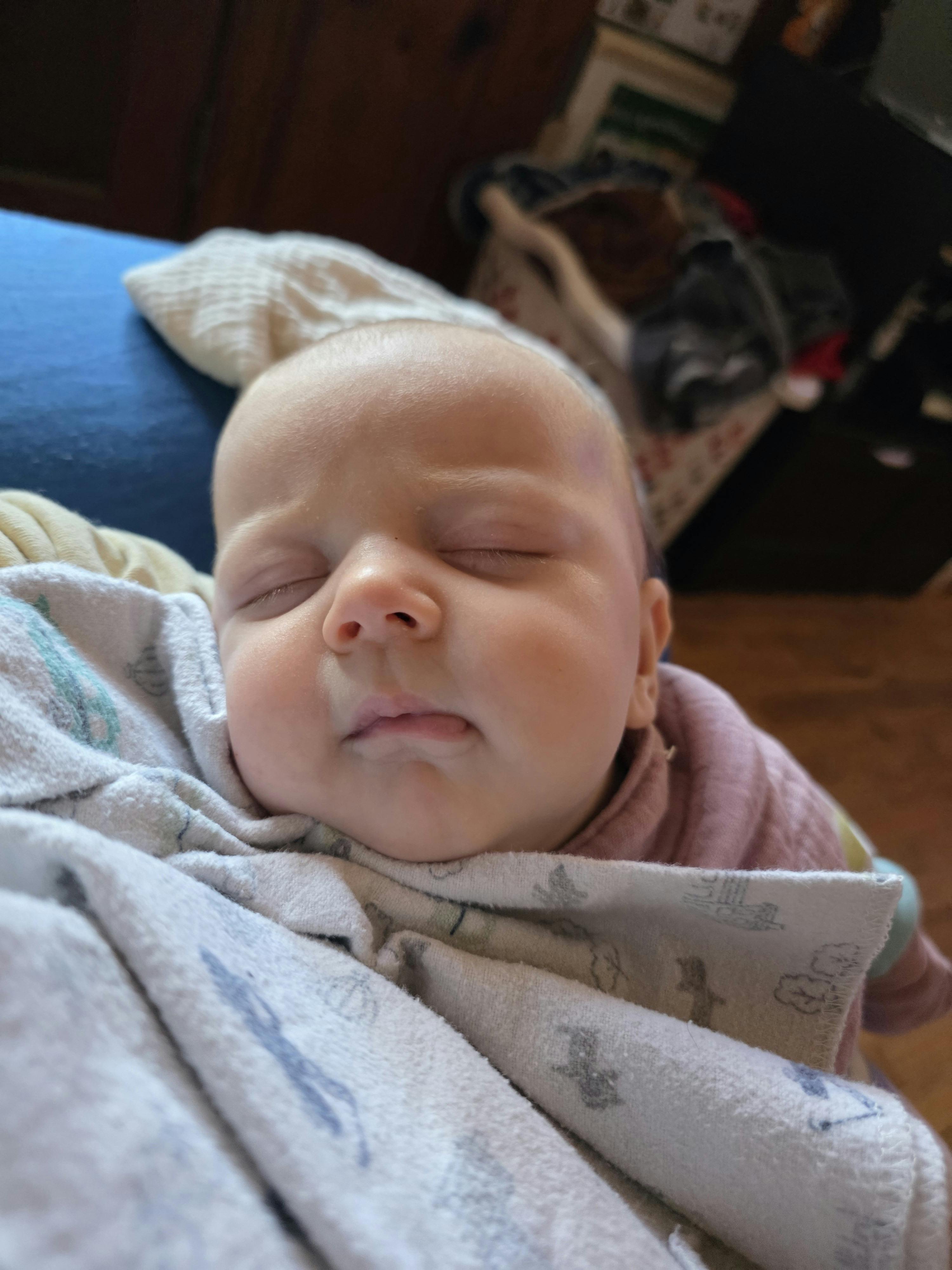 Sleeping child wrapped in a blanket