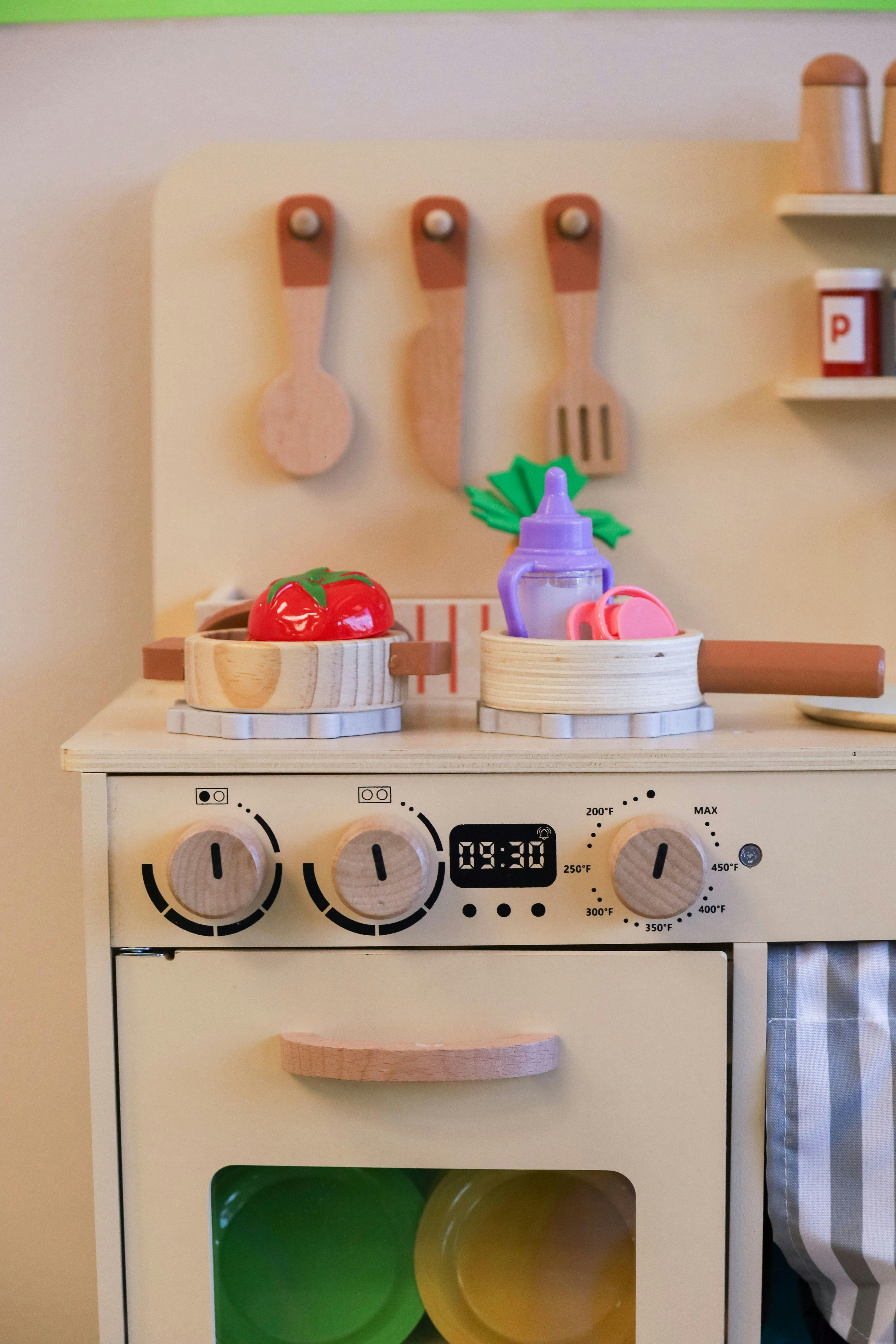 Toy kitchen with play food and utensils