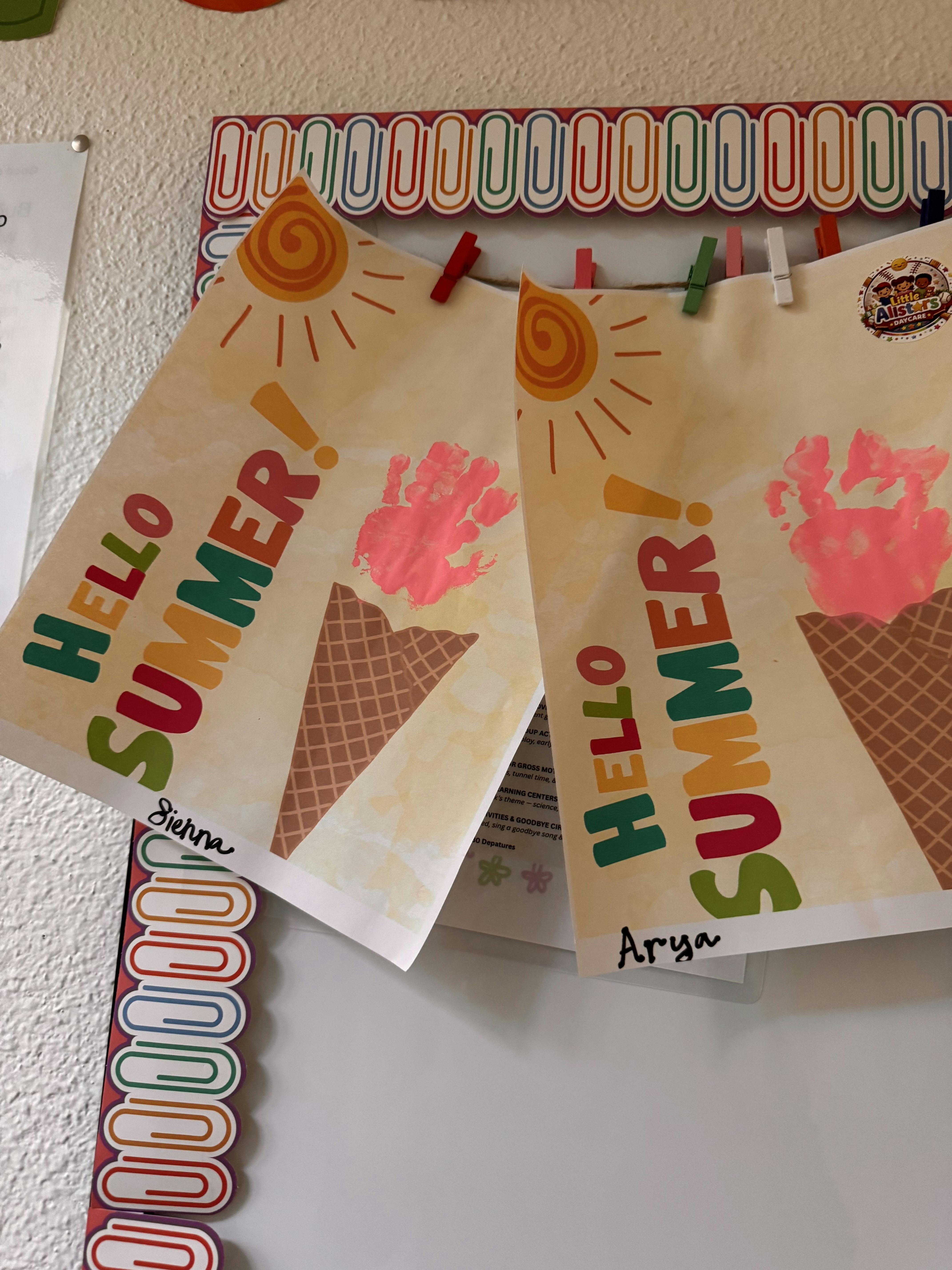 Hello Summer ice cream cone crafts with handprints pinned to a bulletin board