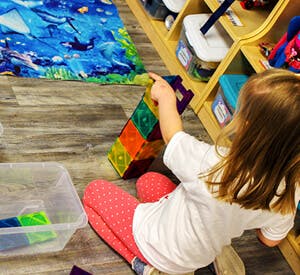 Child playing with colorful magnetic blocks
