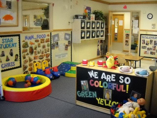 Colorful classroom with play area and bulletin boards