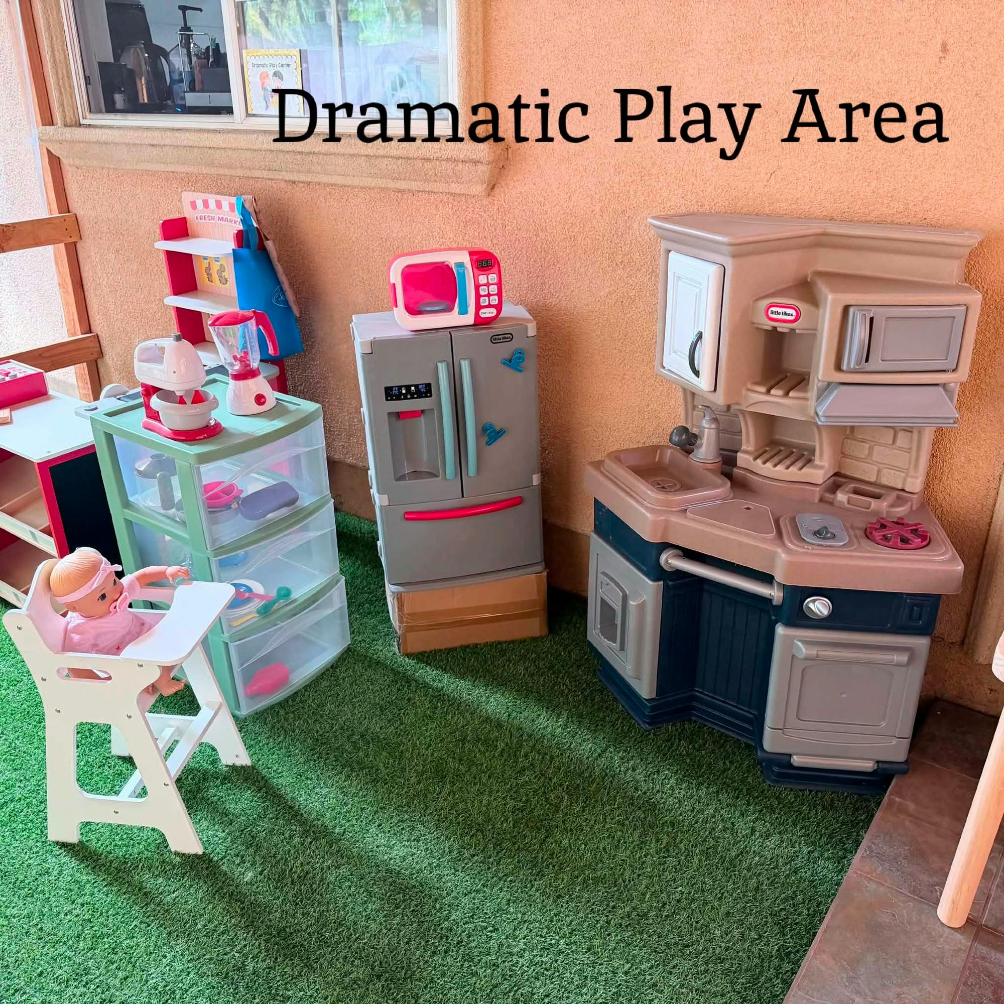 Dramatic play area with toy kitchen set and doll high chair