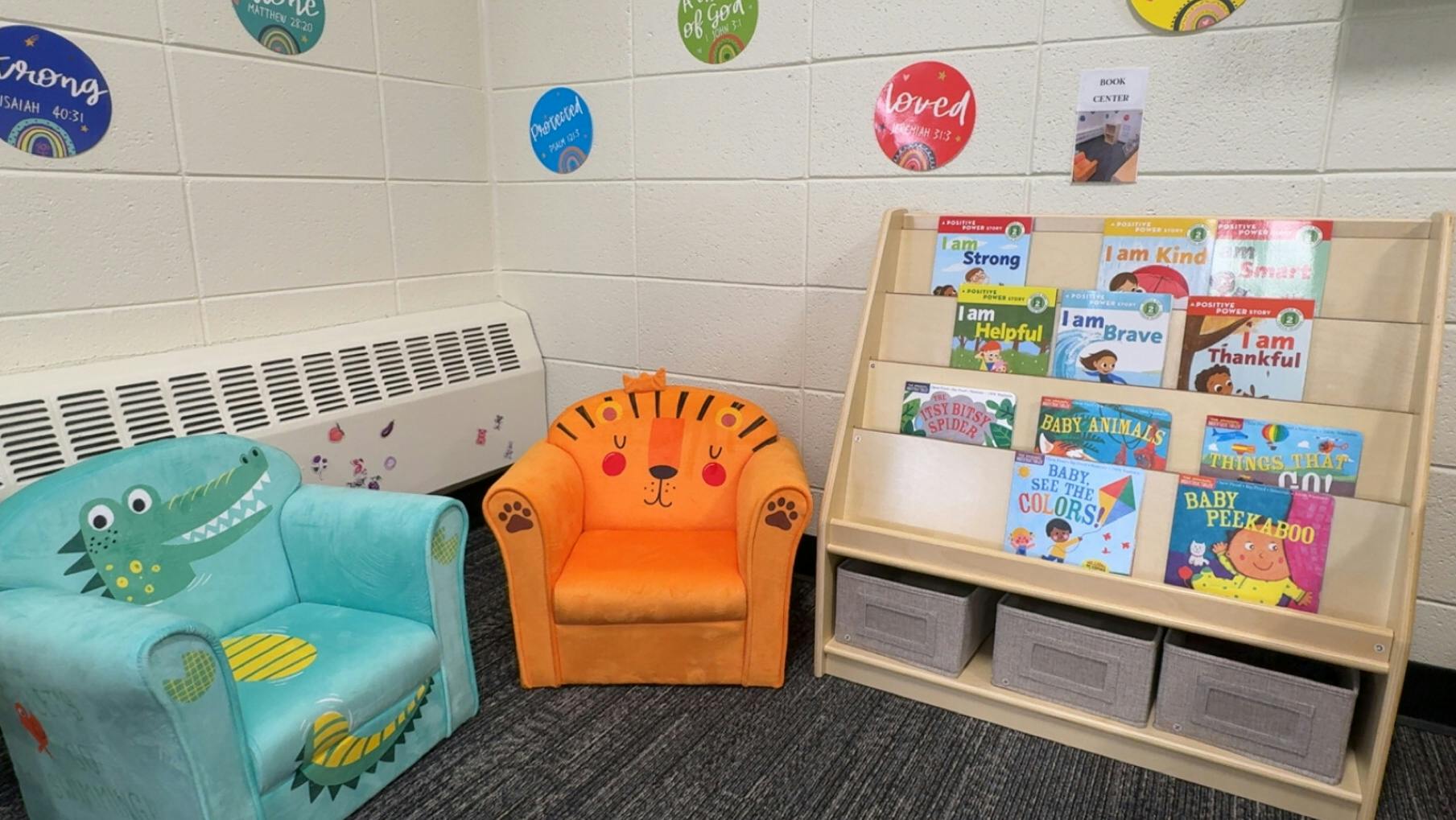 children's reading corner with a book display and animal-themed chairs