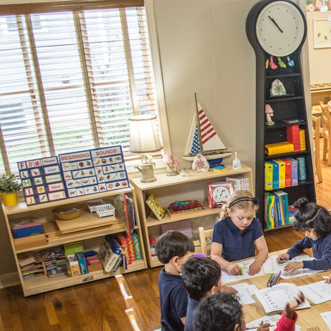 Children sitting at a table in a classroom