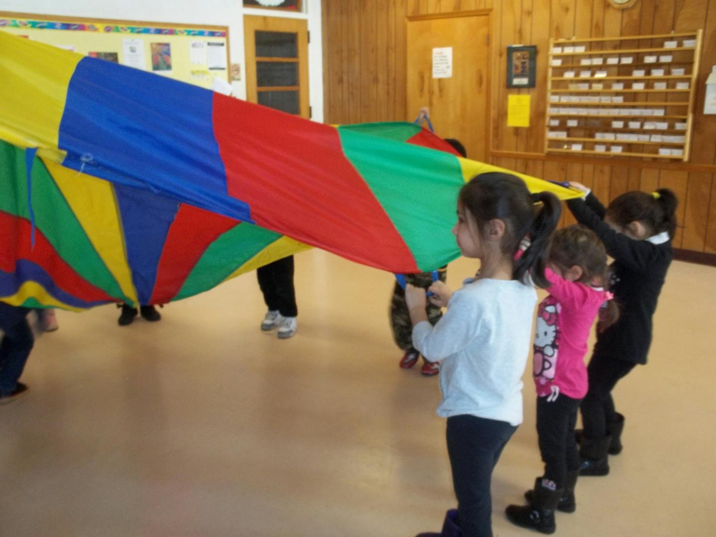 Children holding a colorful parachute