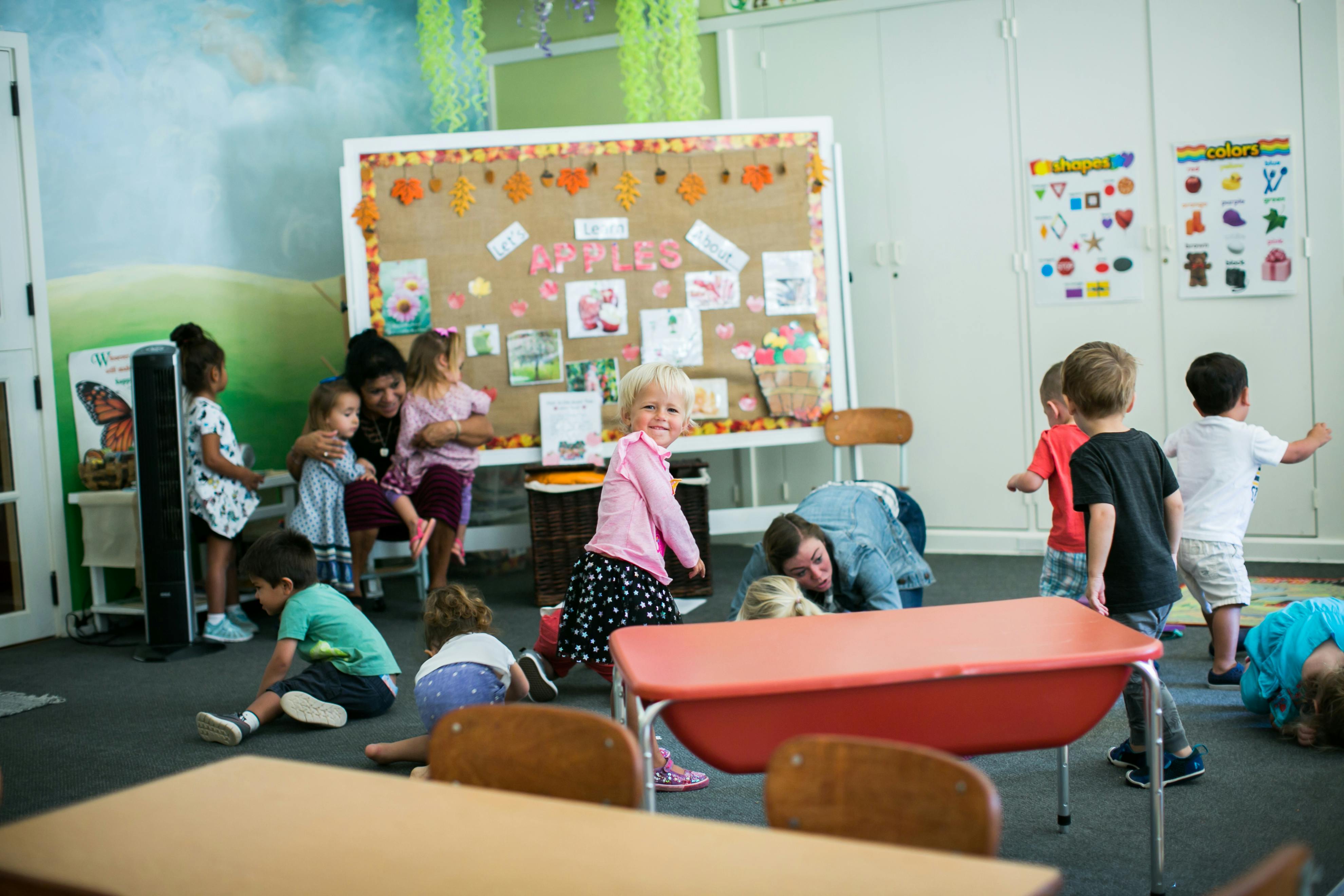 Children and adults interacting in a classroom