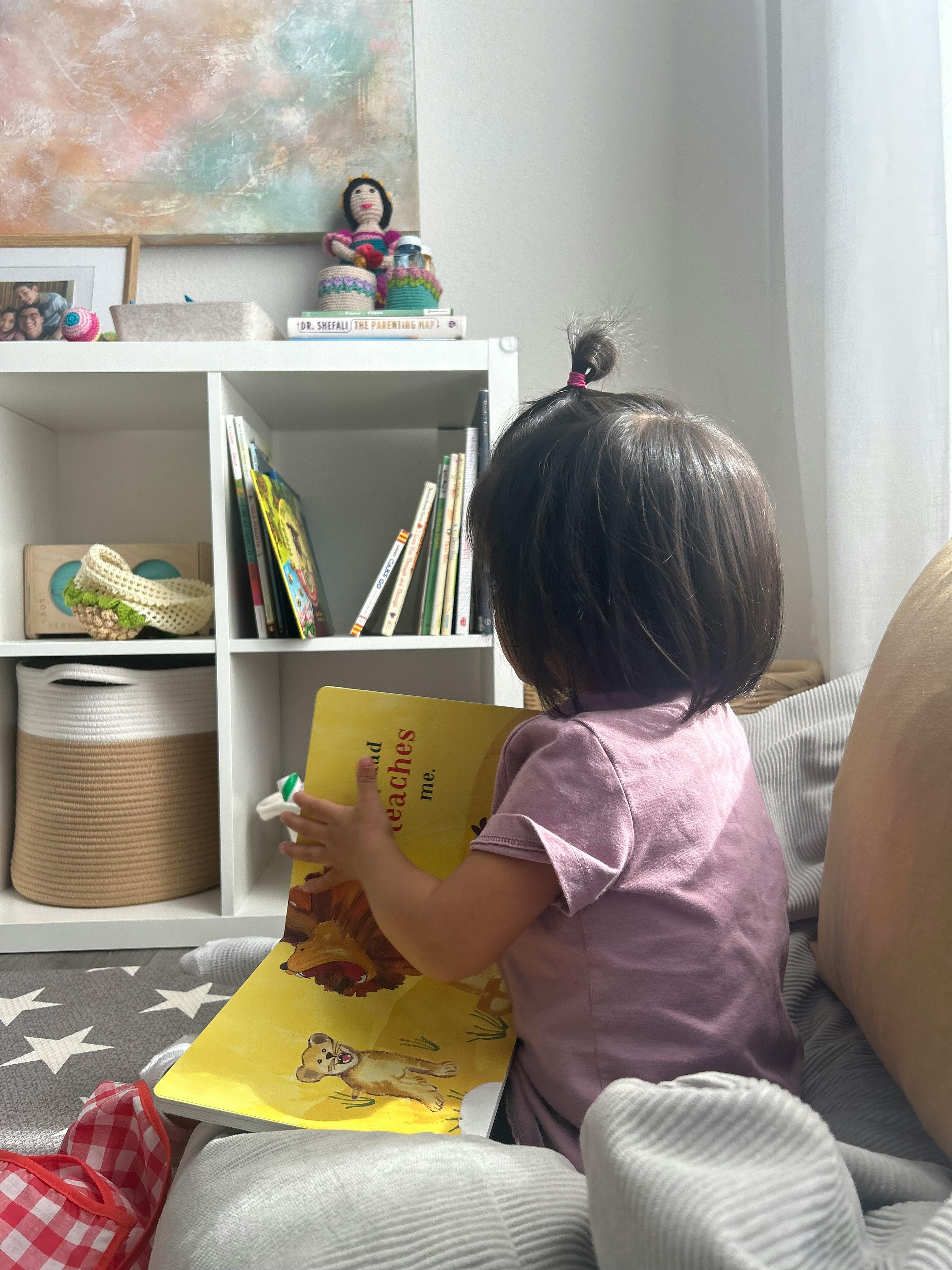 Child reading a book with illustrations