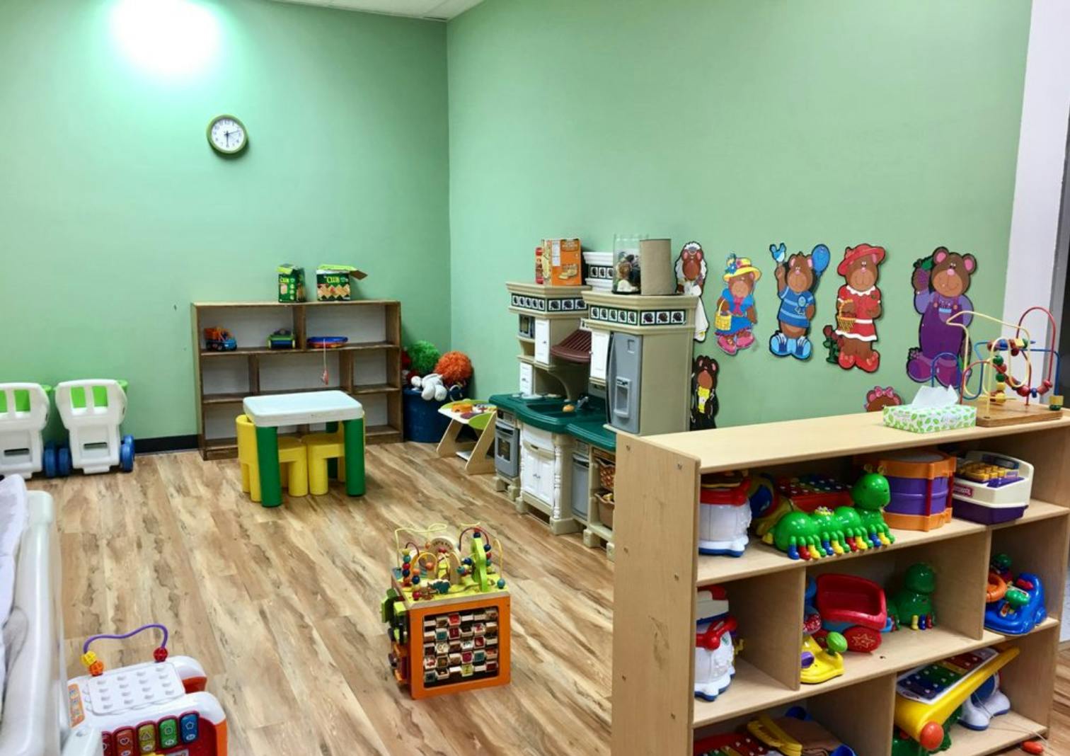 Playroom with toys, shelves, and a small table and chairs