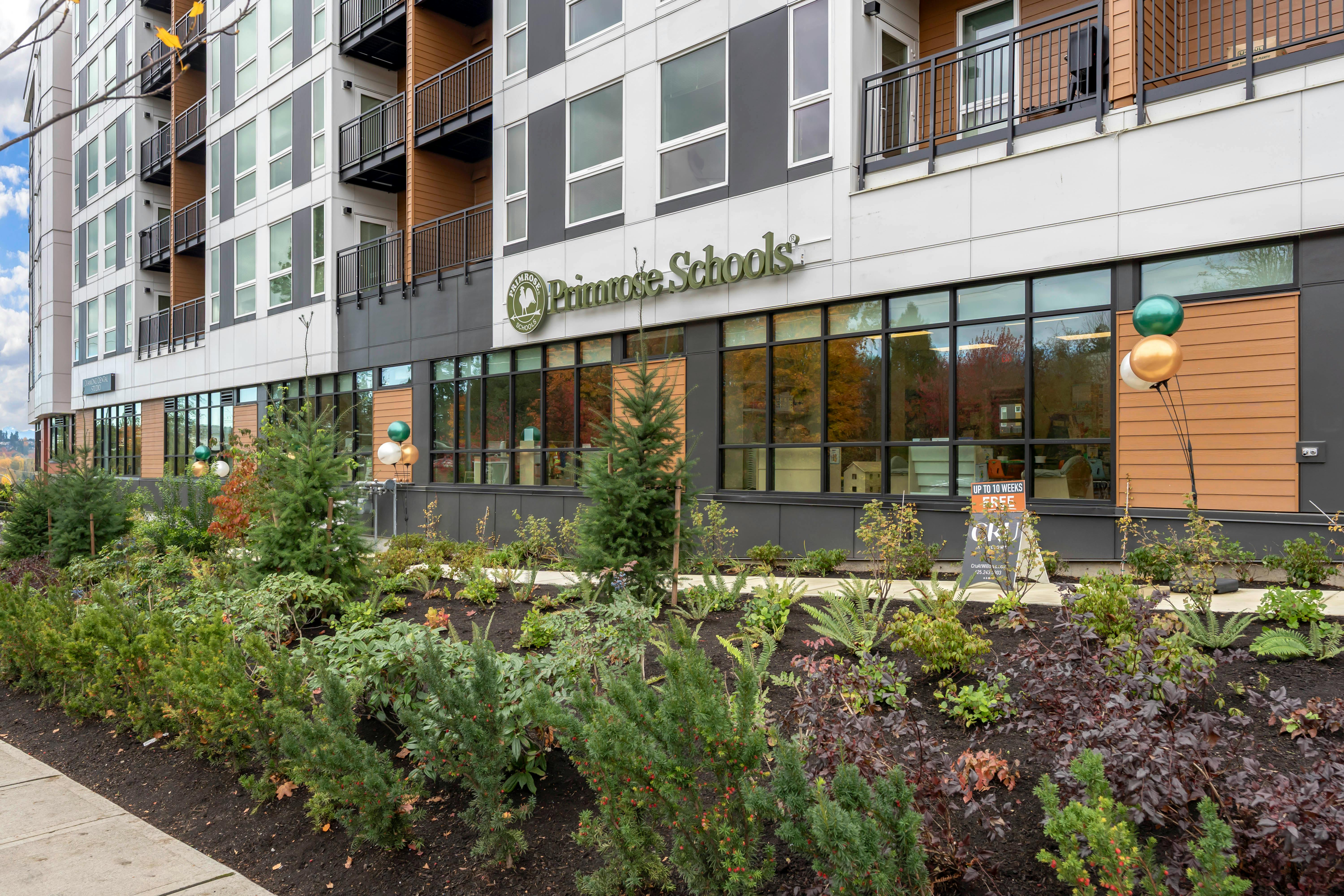 Primrose Schools building exterior with green foliage and brown siding