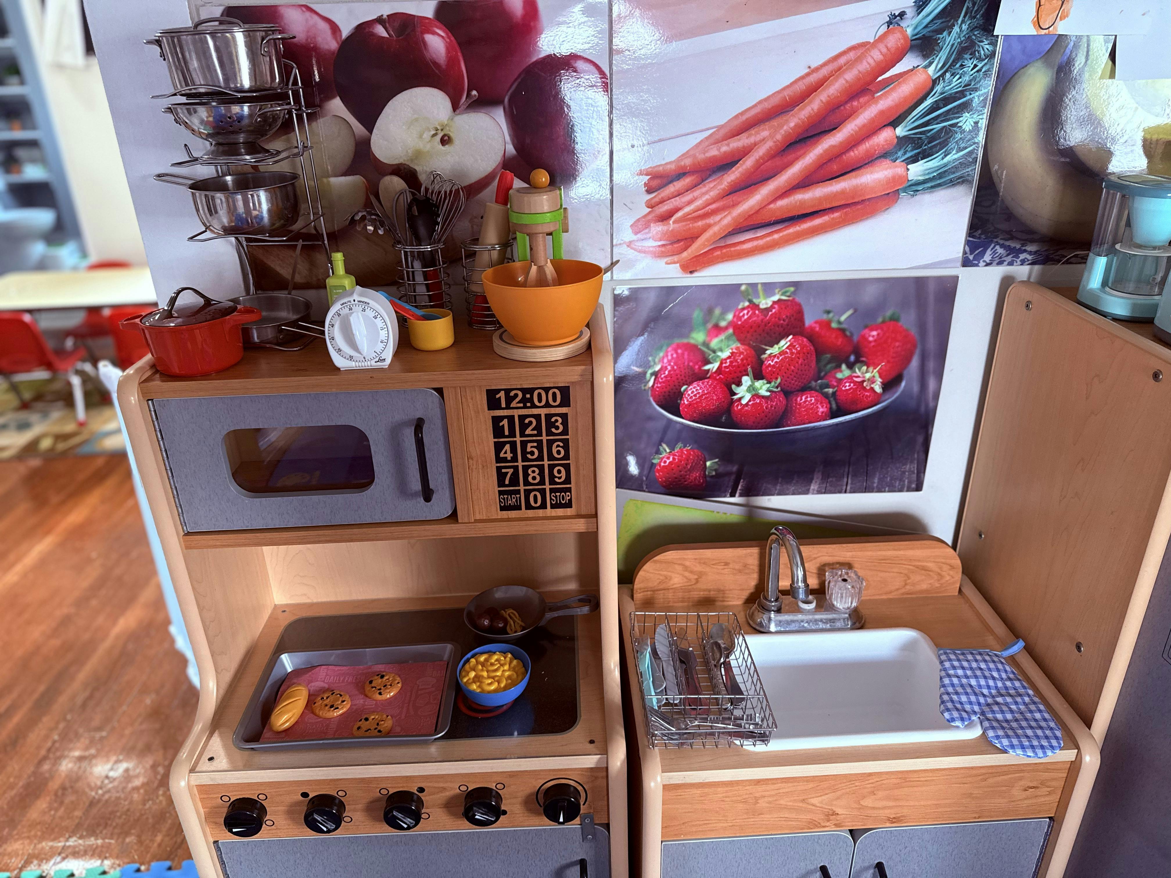 Toy wooden kitchen set with play food and utensils