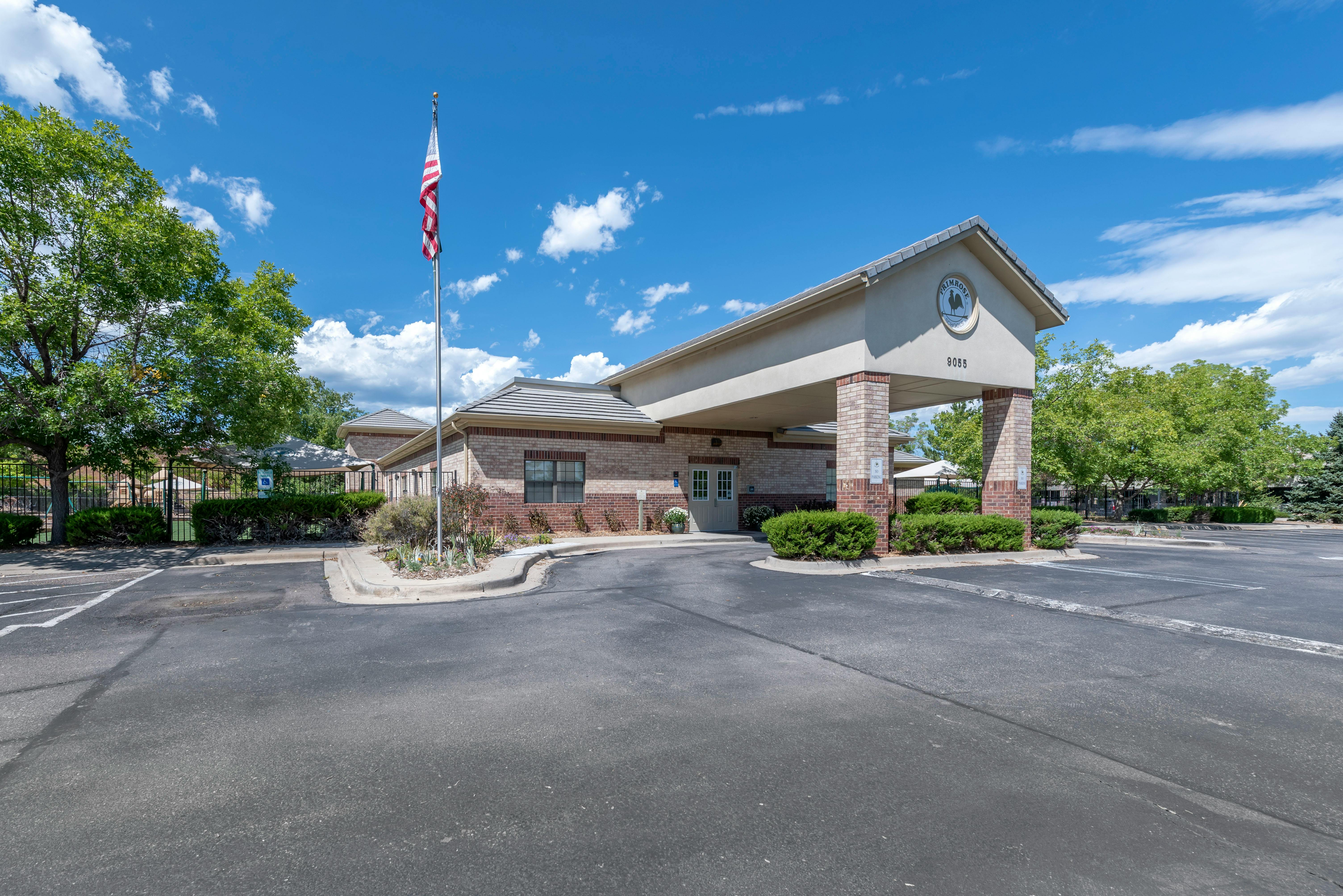 Exterior of a building entrance with an American flag flying