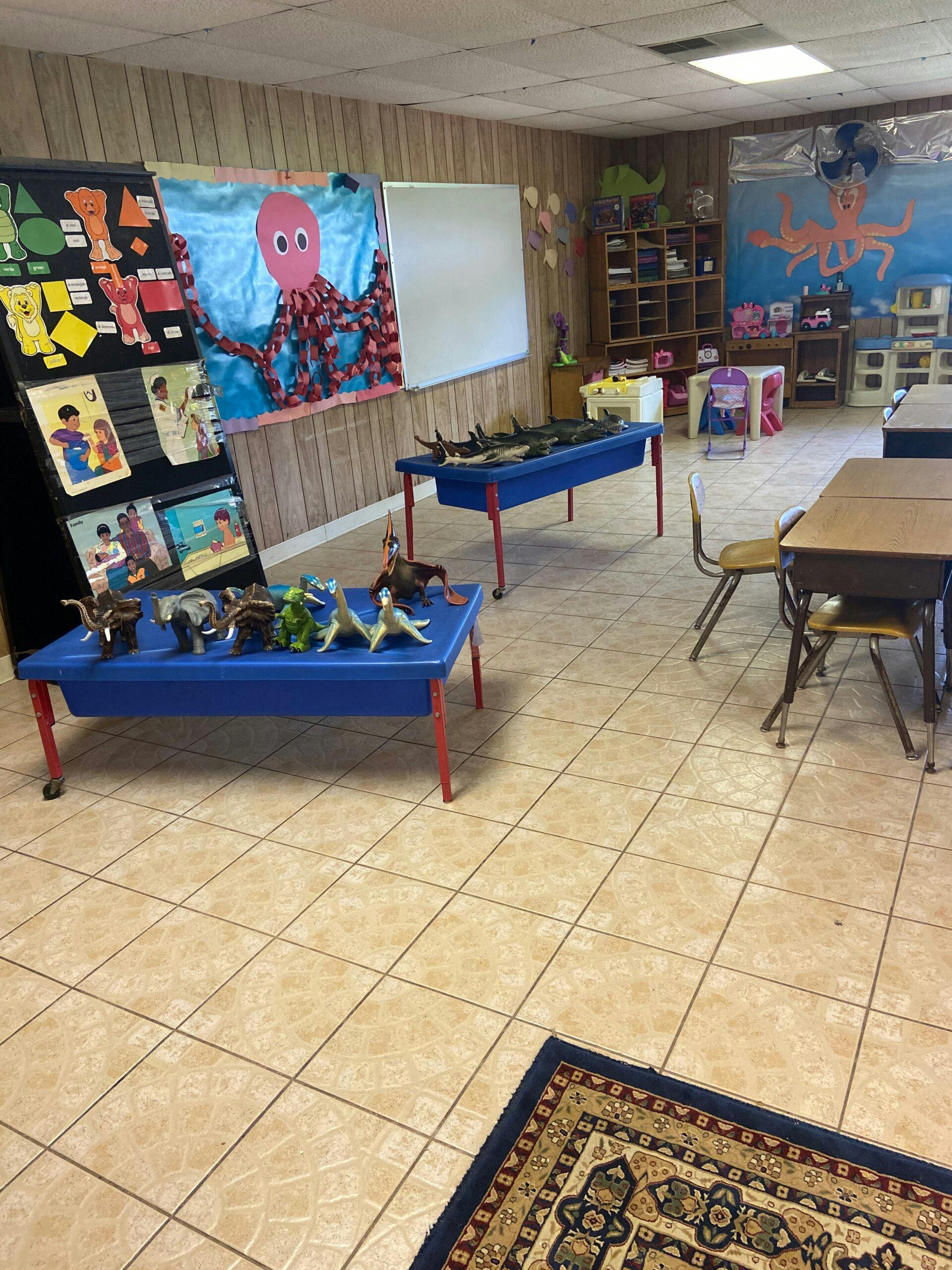 Classroom with blue tables, animal figures, and an octopus decoration