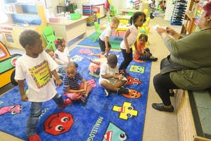 Adult and multiple children in a classroom