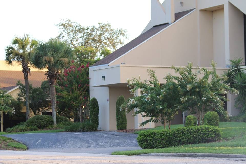 Building exterior with a covered entrance and landscaping