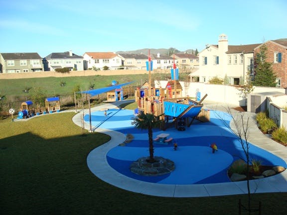 Playground with blue ground and pirate ship structure