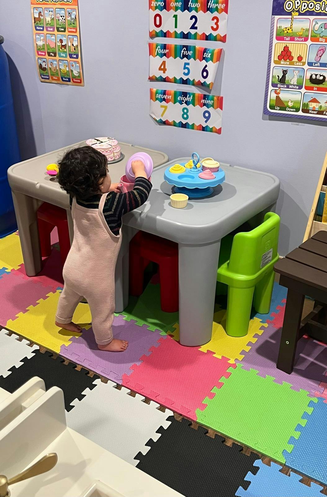 Child playing with toys at a small table