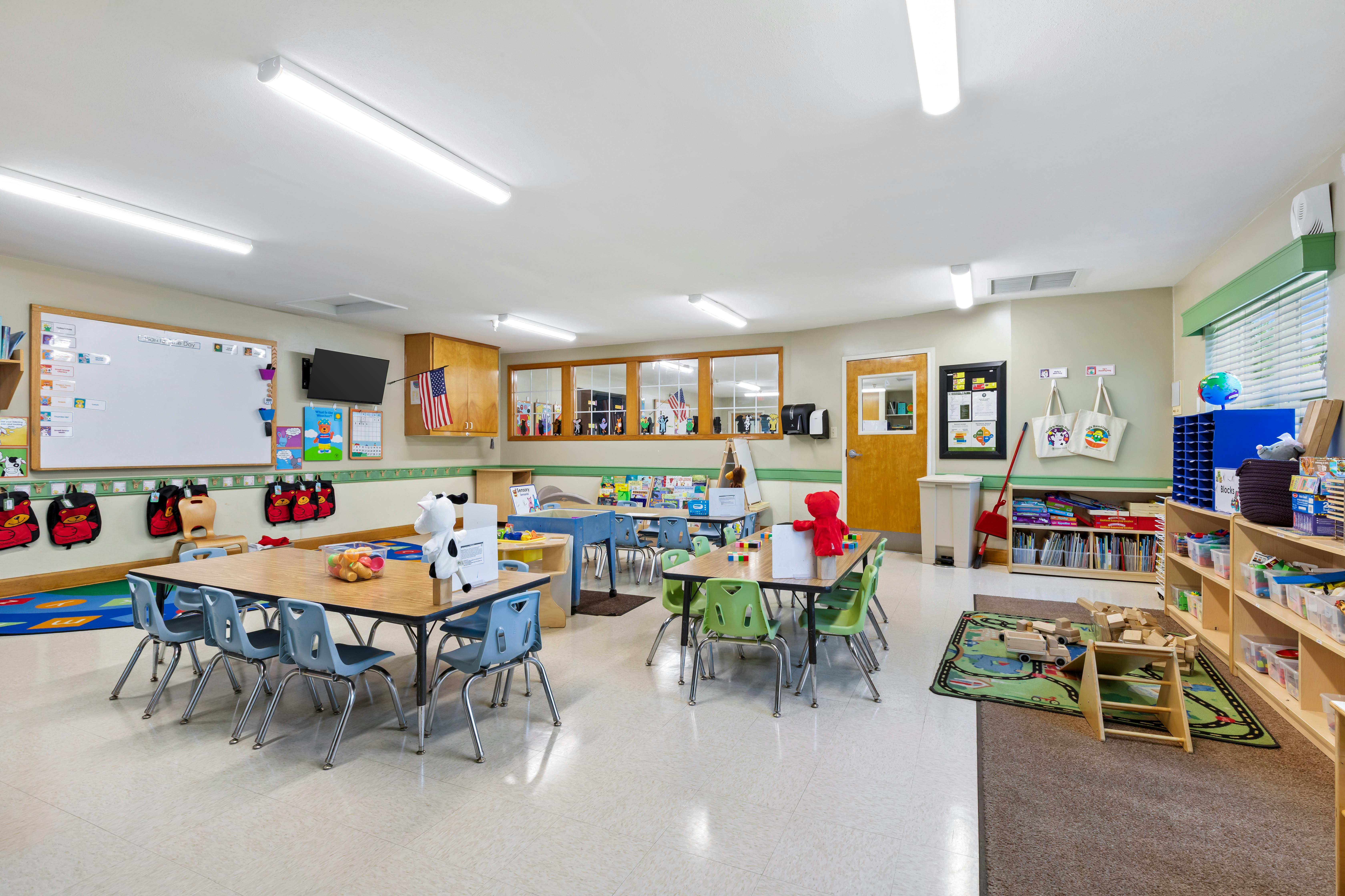 A colorful and organized classroom with child-sized tables and chairs
