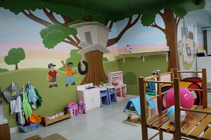 Playroom with tree mural and children's furniture