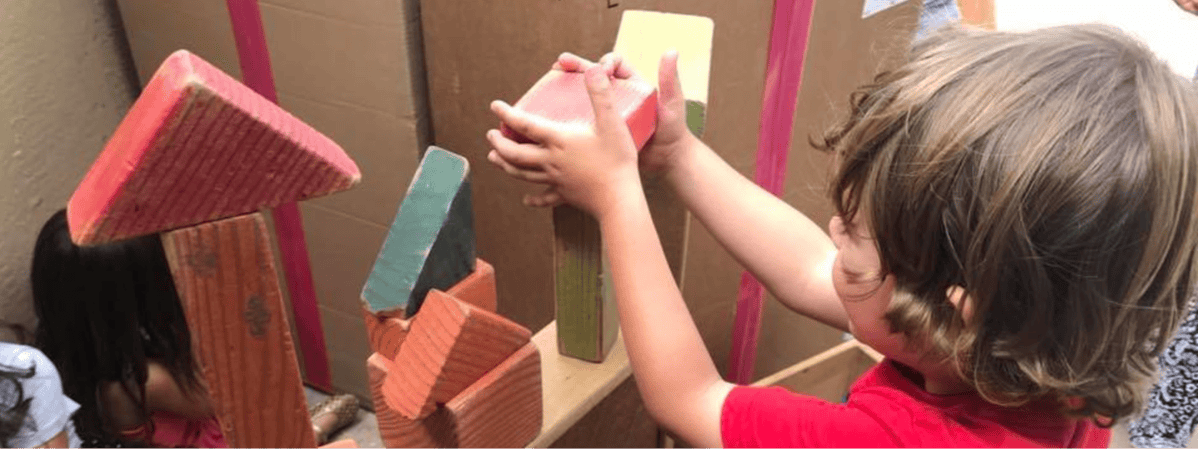 Child stacking wooden blocks