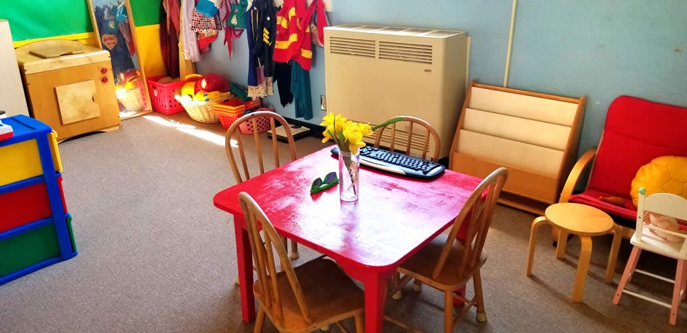 Red table and chairs in a classroom