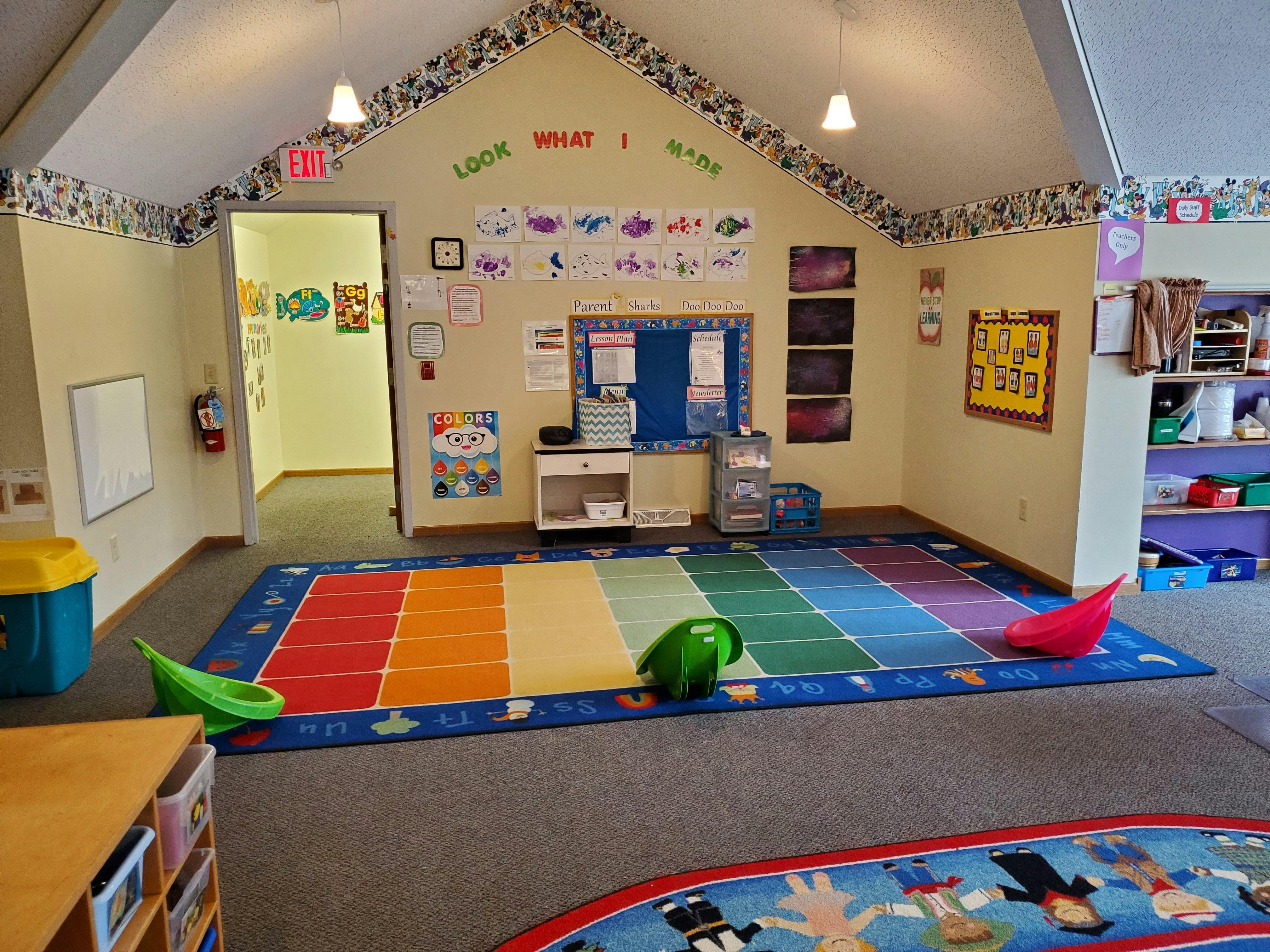 Classroom with a colorful rainbow rug on the floor