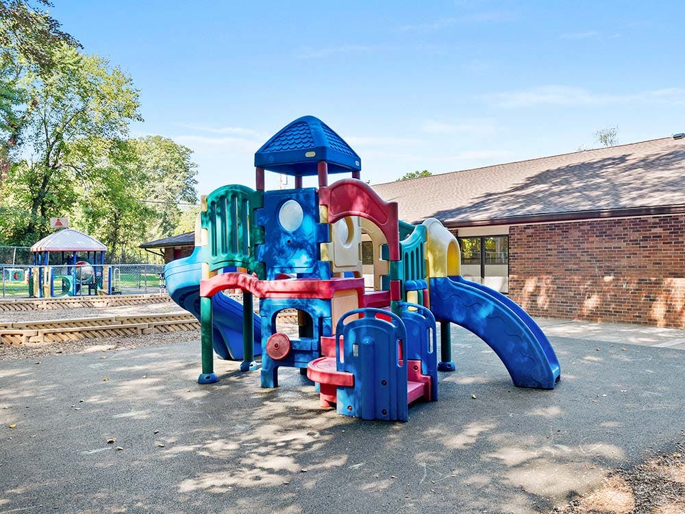 Colorful playground structure with slides and climbing areas