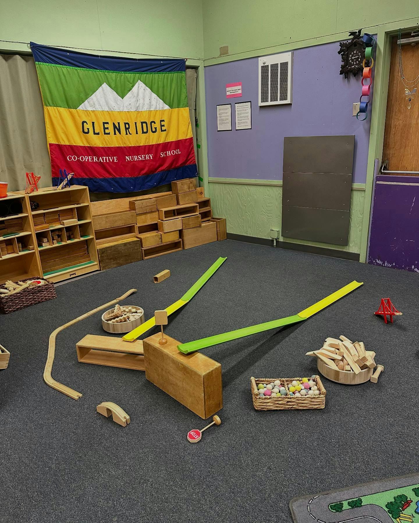 Playroom with wooden blocks, ramps, and a banner for Glenridge Co-operative Nursery School