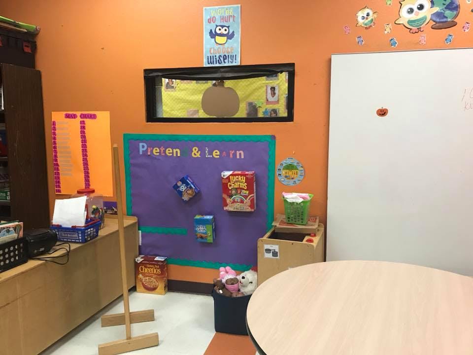 Classroom with a purple bulletin board and a white board
