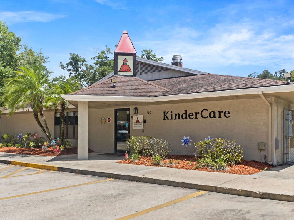 KinderCare building with palm trees and landscaping