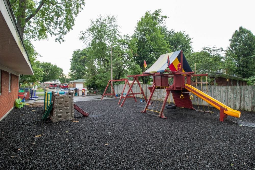 Outdoor playground with swings, slide, and climbing structure