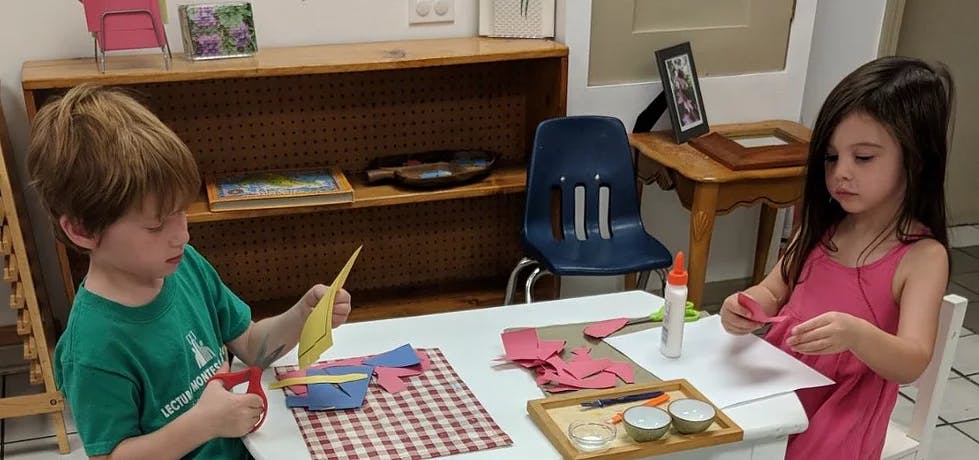 Two children doing crafts at a table