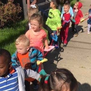 Children walking in a line outdoors