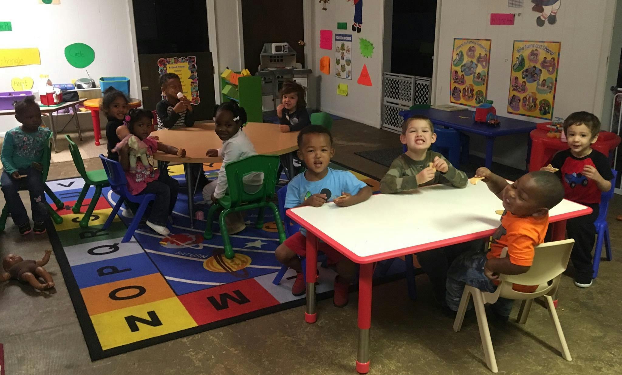 Children sitting at tables in a classroom