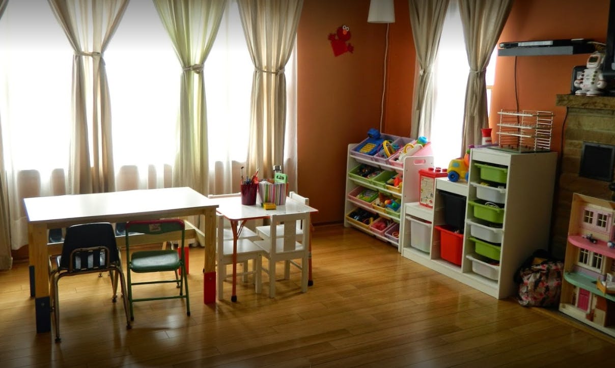 Playroom with tables, chairs, and toy storage shelves