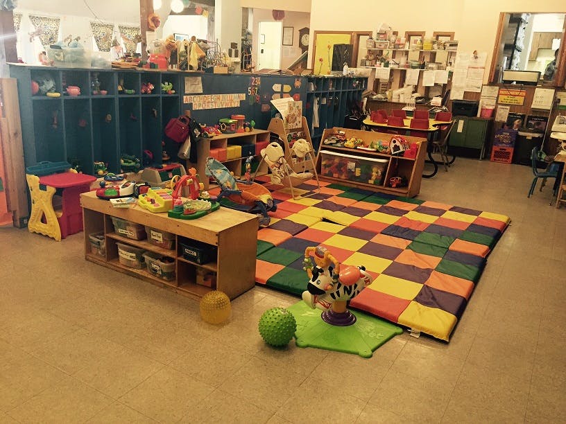Playroom with a colorful checkered mat and various toys