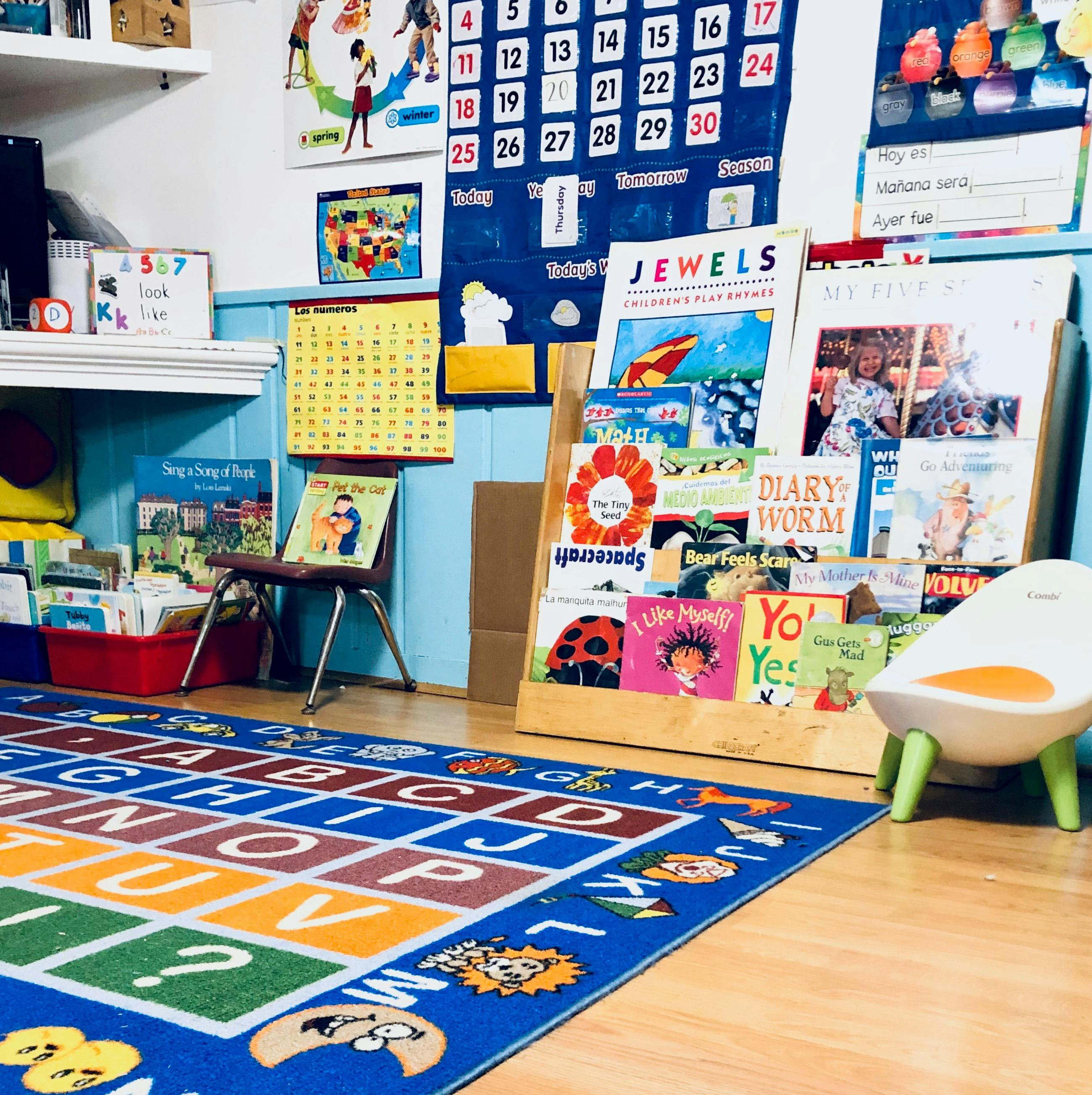 Classroom with an alphabet rug, book display, and calendar